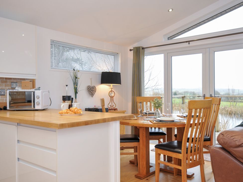 A kitchen with a table and chairs at 15 Faraway Fields in Dobwalls