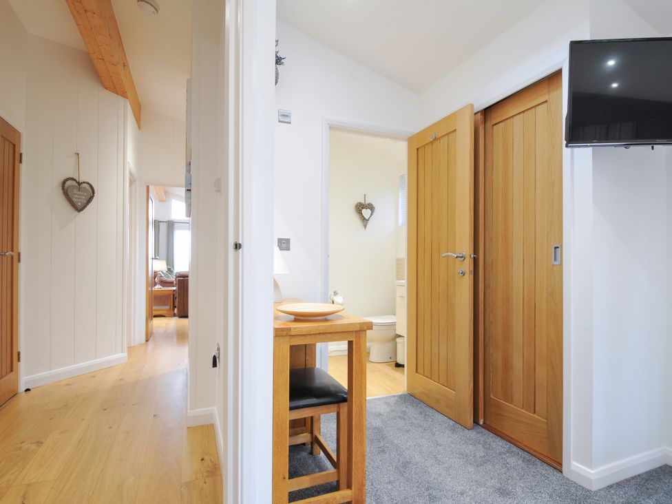 A hallway with wooden doors and a table at 15 Faraway Fields Dobwalls