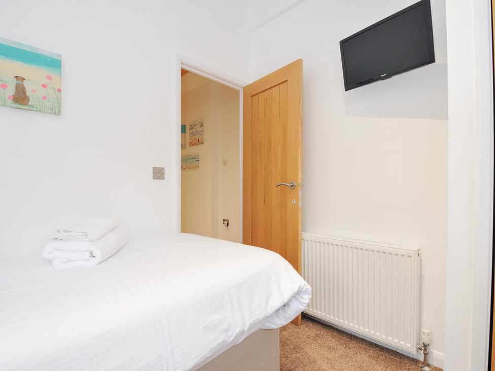 A bedroom with a bed and a wall-mounted TV at 15 Faraway Fields in Dobwalls