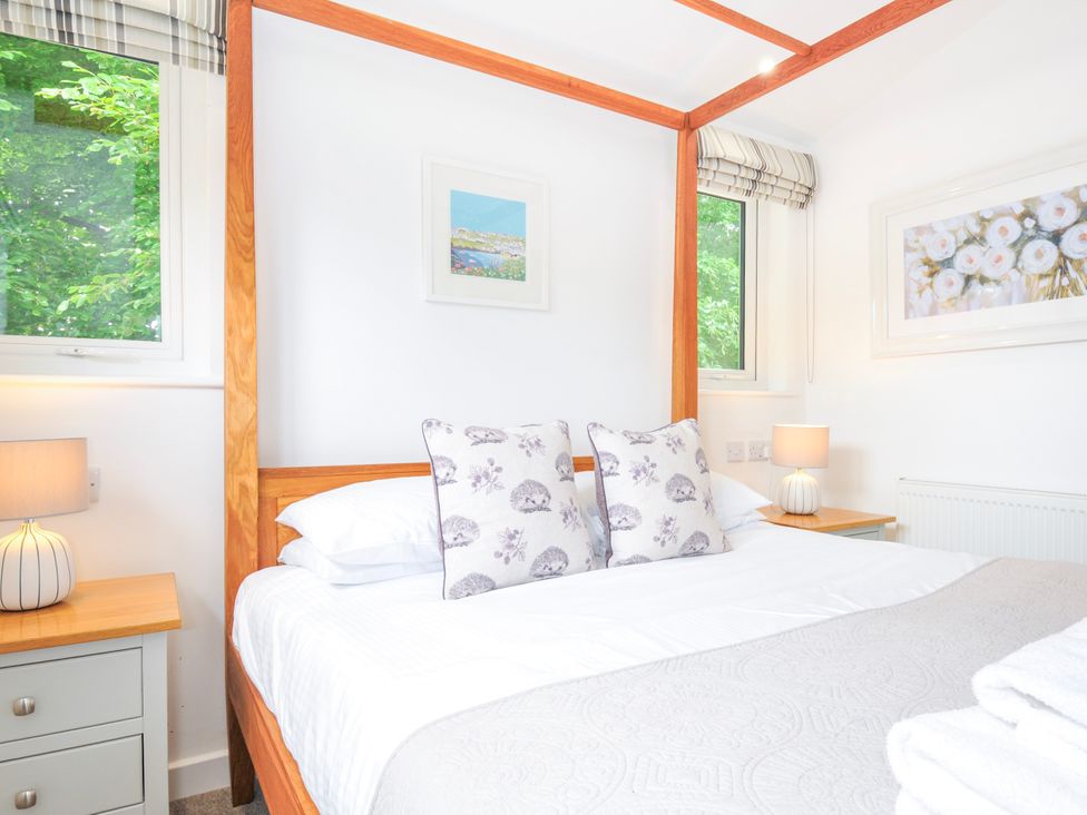 A bedroom with a four-poster bed and bedside table at 1 Horizon View in Dobwalls