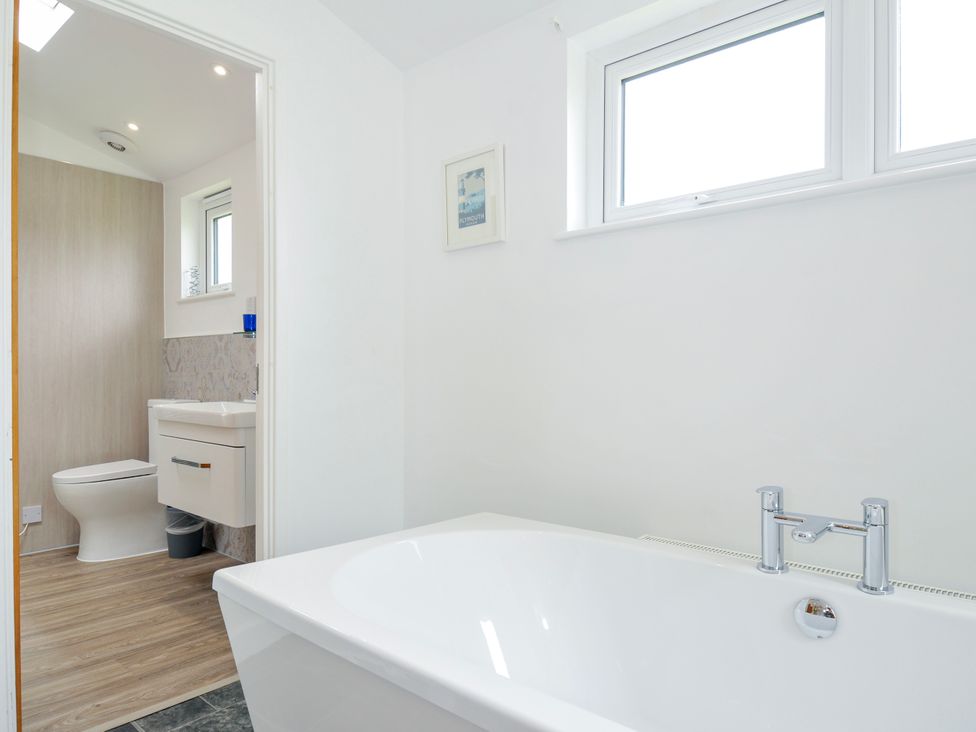 A bathroom featuring a bathtub and toilet at 1 Horizon View, Dobwalls