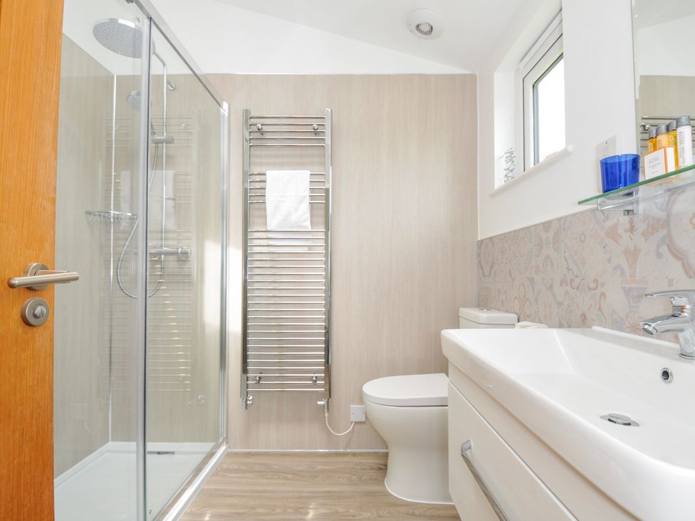 A bathroom with a shower, toilet, and sink at 1 Horizon View in Dobwalls