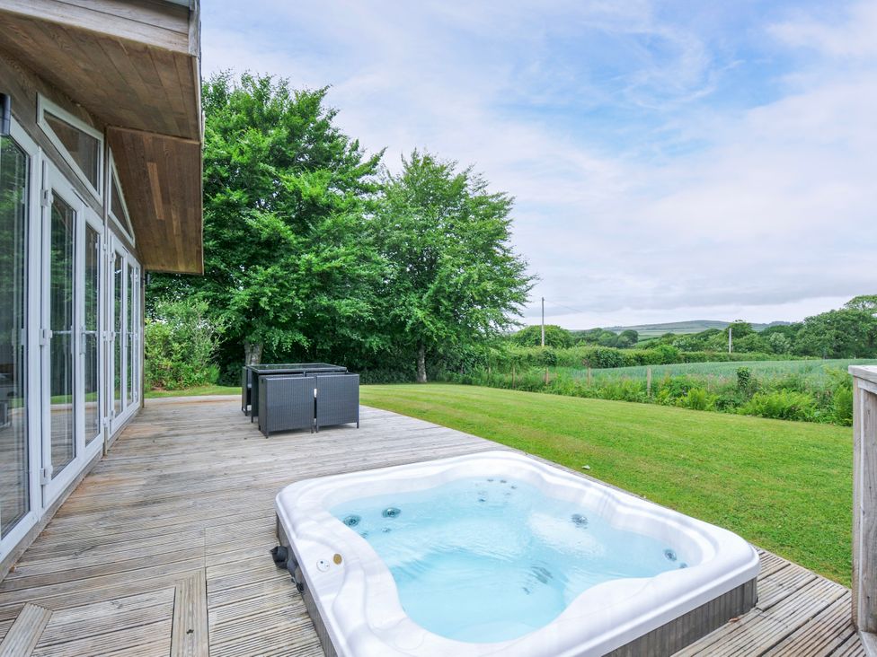 An outdoor area with a hot tub and seating at 1 Horizon View in Dobwalls