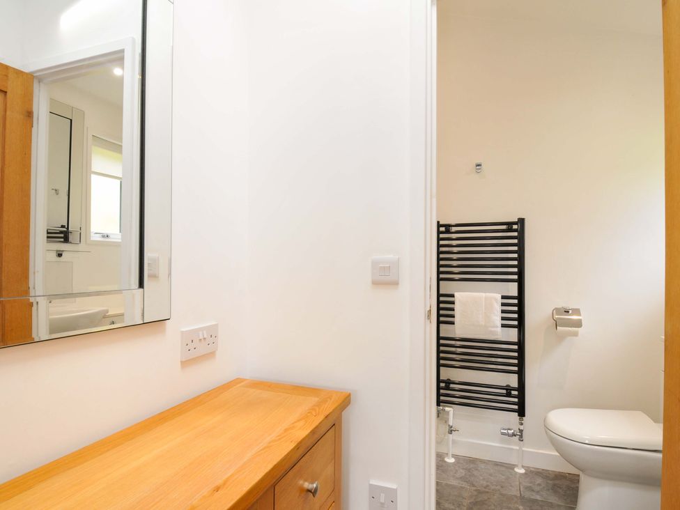 A bathroom with a mirror and wooden cabinet at 3 Horizon View in Dobwalls
