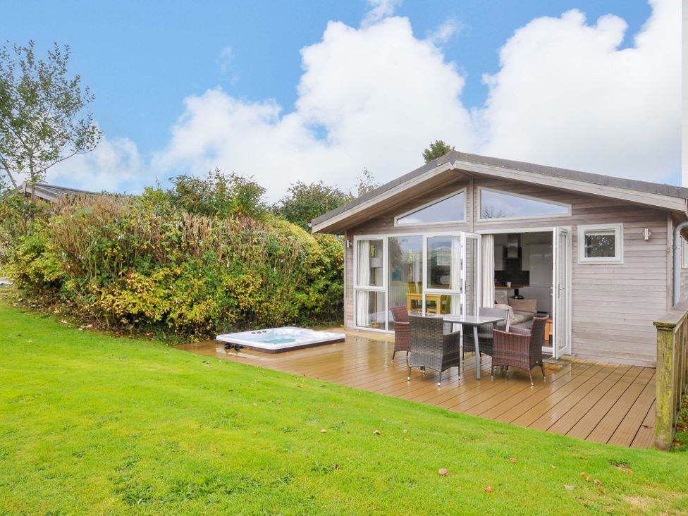 An outdoor area with a wooden cabin and a hot tub at 3 Horizon View in Dobwalls