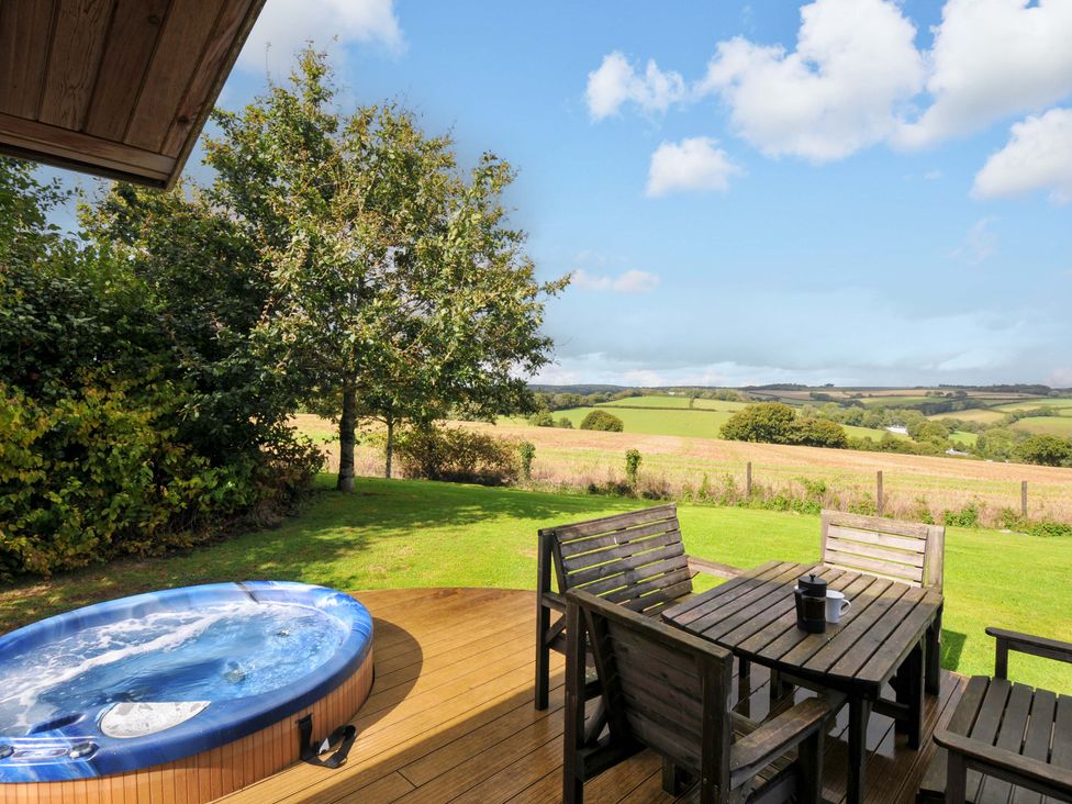 A garden with a hot tub and wooden furniture at 8 Horizon View Dobwalls