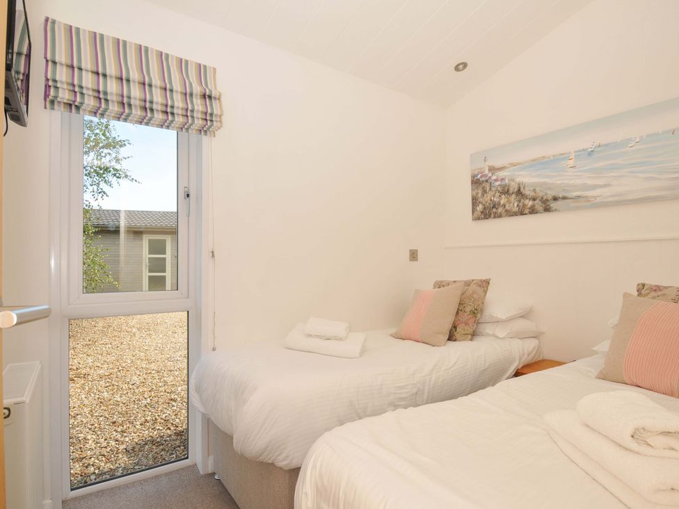 A bedroom with two single beds and a window at 8 Horizon View Dobwalls