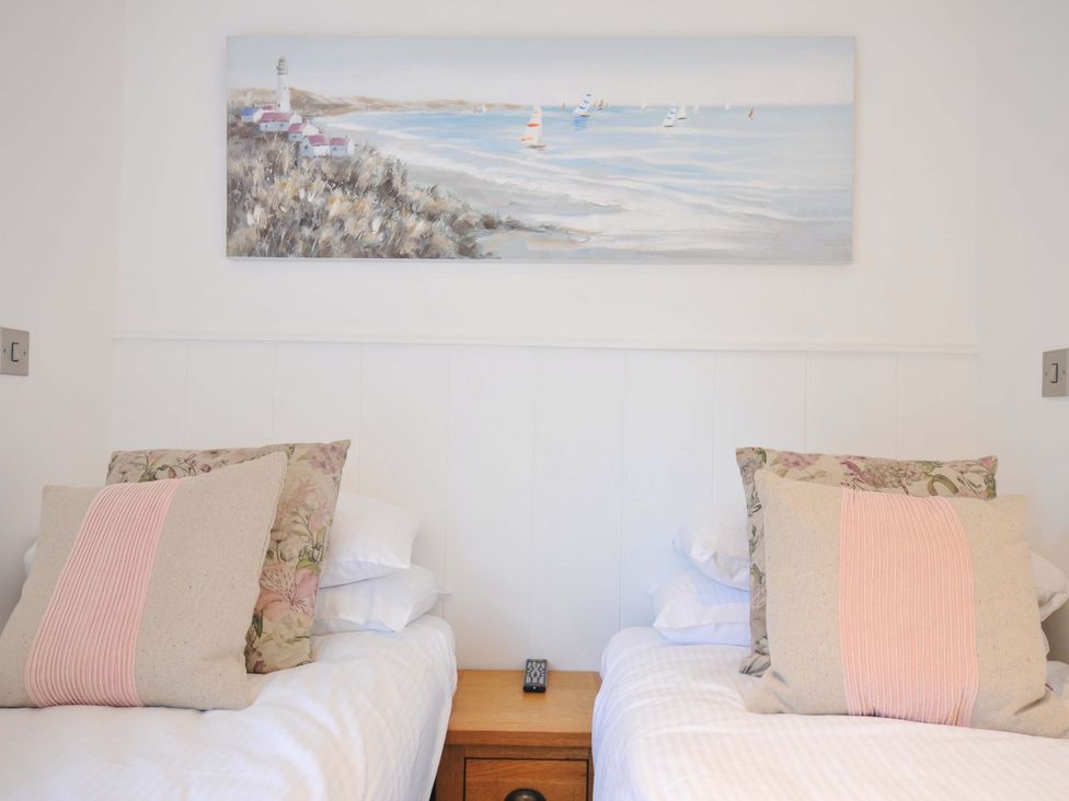 A bedroom with two beds and a painting on the wall at 8 Horizon View in Dobwalls