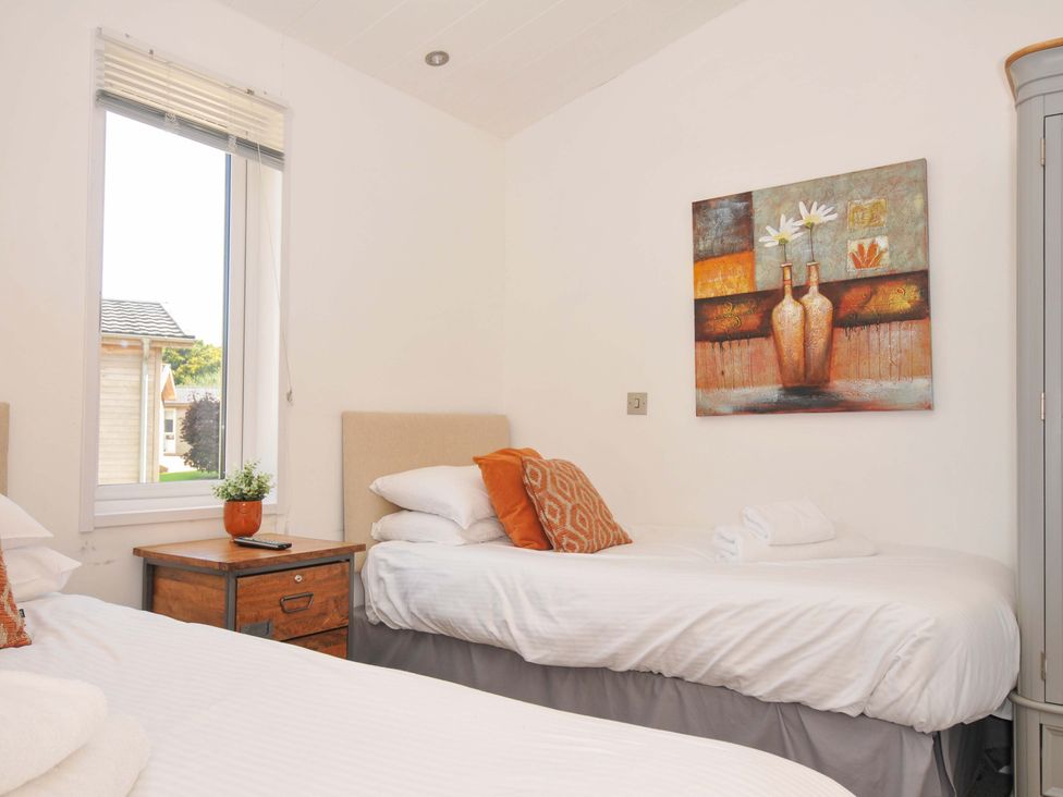 A bedroom with two beds and a window at 8 Horizon View in Dobwalls
