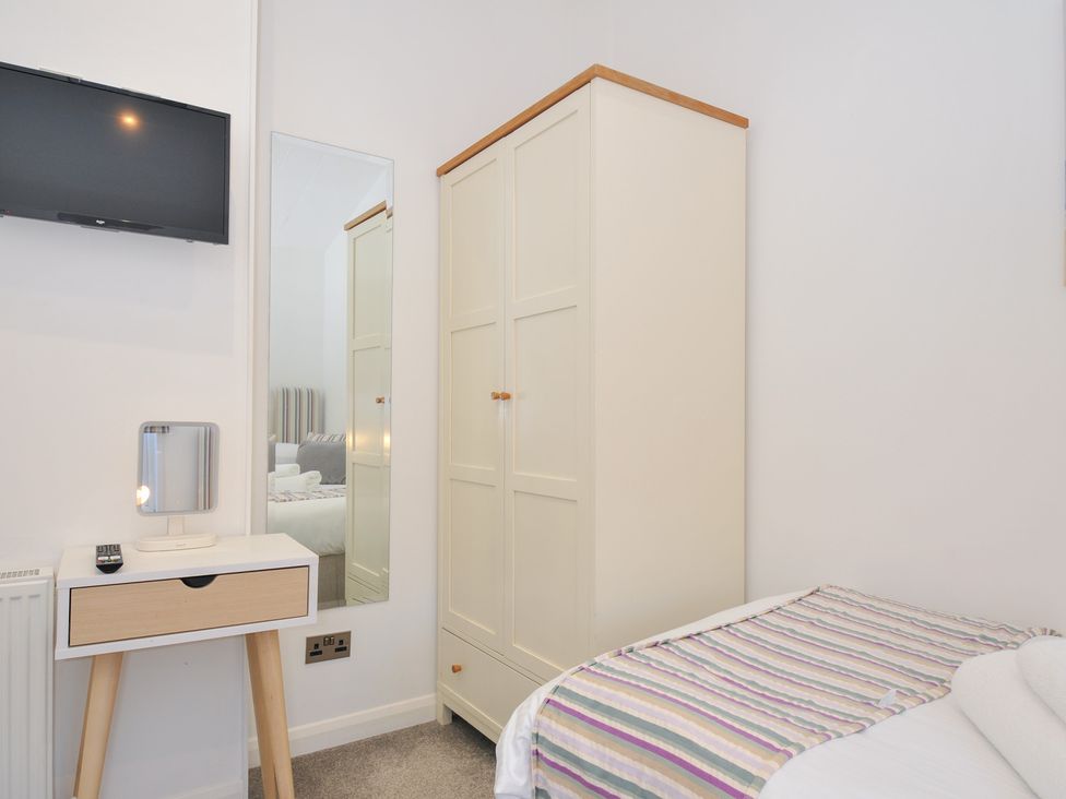 A bedroom with a wardrobe and television at 9 Horizon View Dobwalls