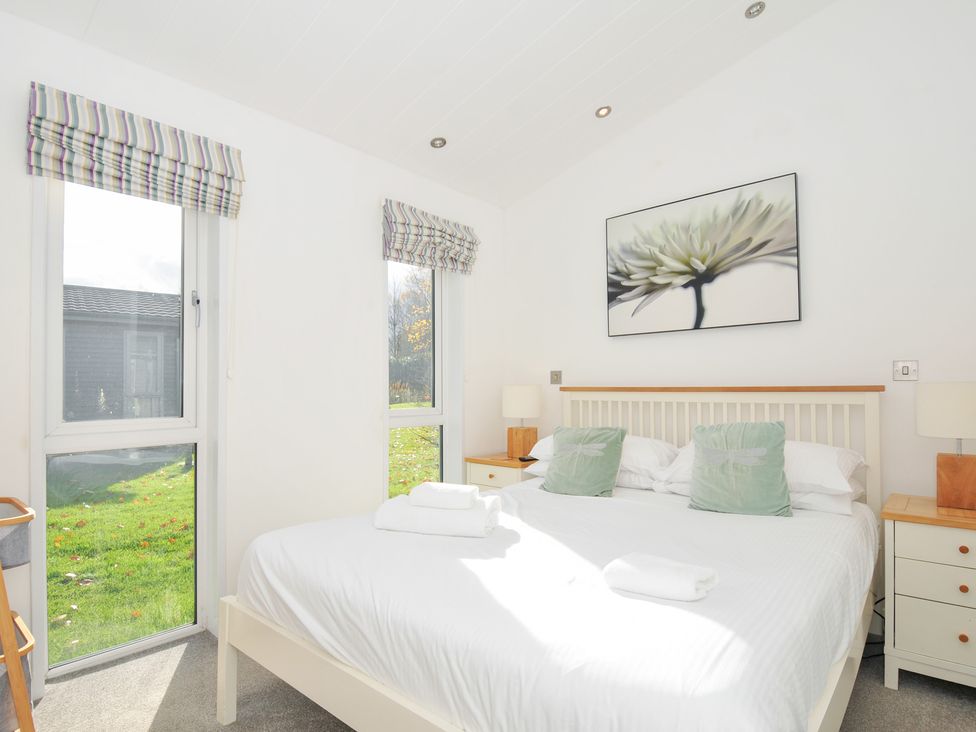 A bedroom with a bed and windows at 9 Horizon View in Dobwalls