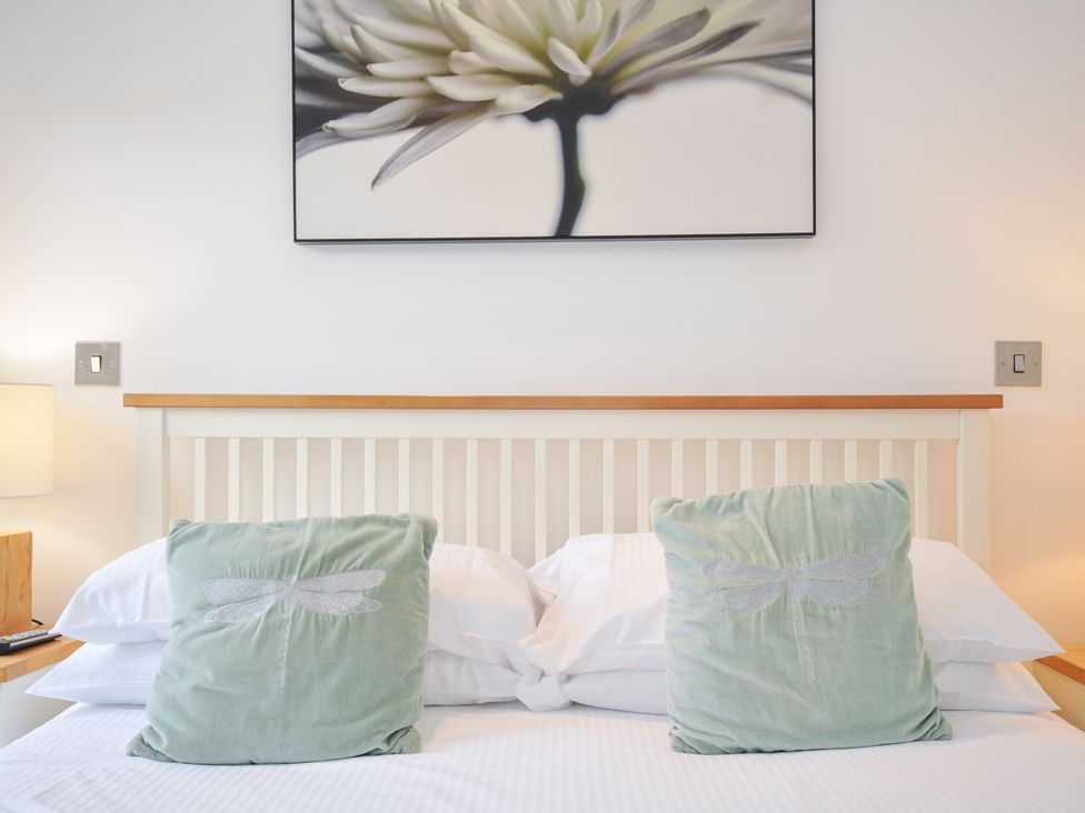 A bedroom with pillows on a bed and a picture on the wall at 9 Horizon View in Dobwalls