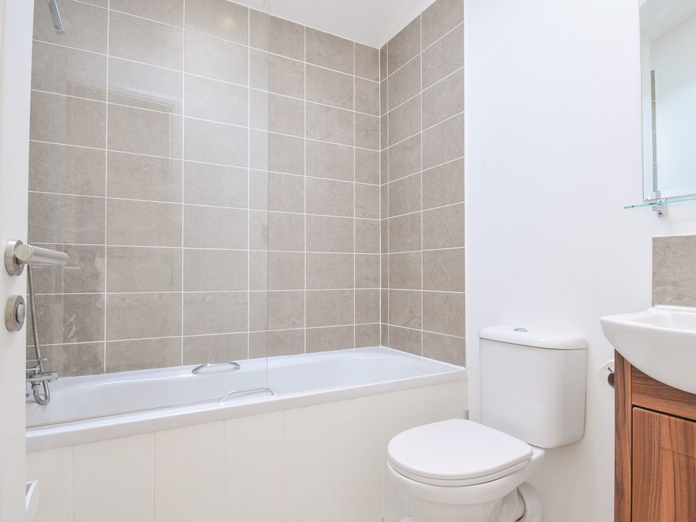 A bathroom with a bathtub, toilet, and sink at 9 Horizon View Dobwalls