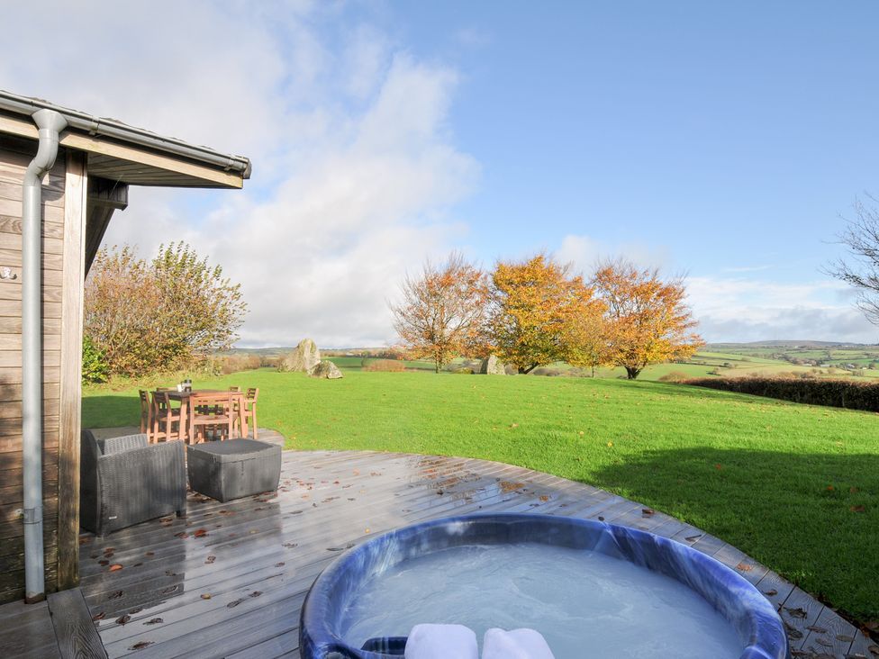 An outdoor area with a hot tub and a dining table at 9 Horizon View Dobwalls