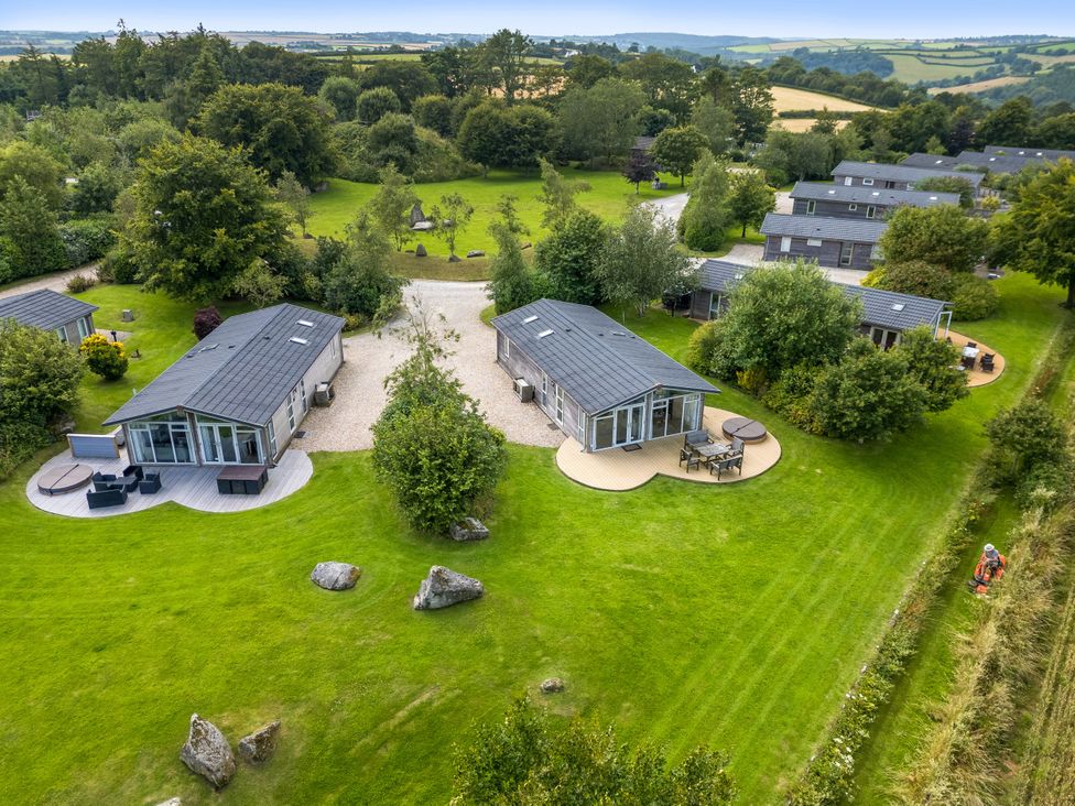 An outdoor area with cabins, grass, and trees at 10 Horizon View in Dobwalls