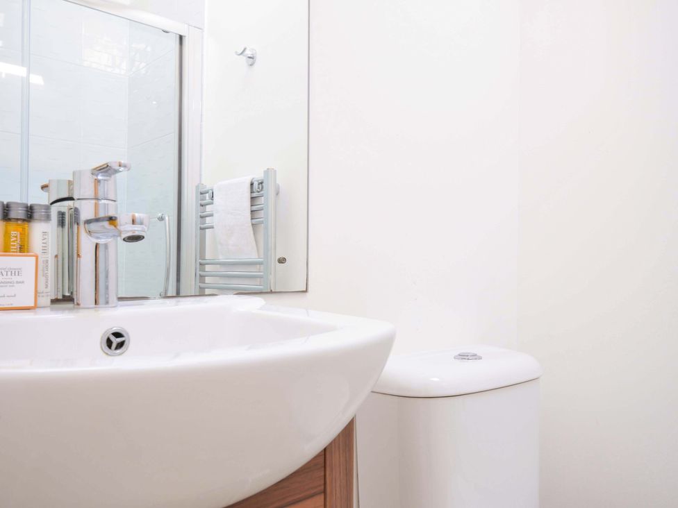 A bathroom with a sink, toilet, and towel rack at 10 Horizon View in Dobwalls