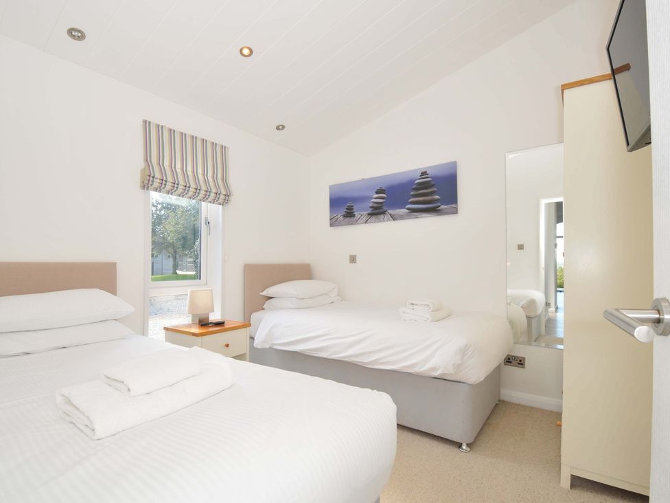 A bedroom with two beds and a window at 10 Horizon View, Dobwalls