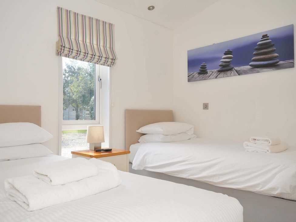 A bedroom with two beds and a window at 10 Horizon View Dobwalls