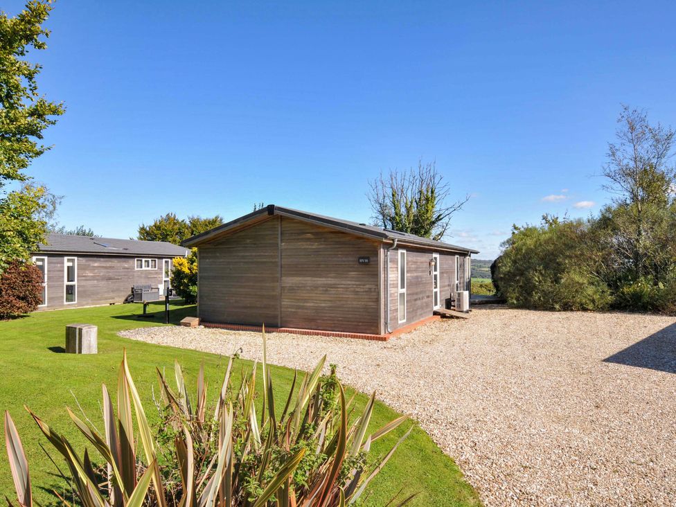 An outdoor area with wooden cabins and green grass at 10 Horizon View in Dobwalls