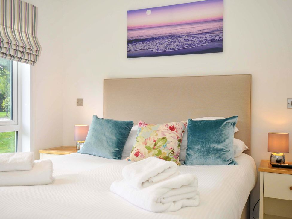 A bedroom with a bed and nightstands at 11 Horizon View Dobwalls