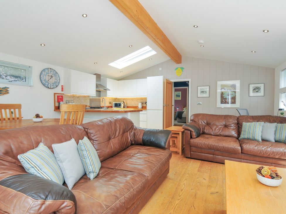 A living room with a sofa and dining area at 15 Horizon View, Dobwalls