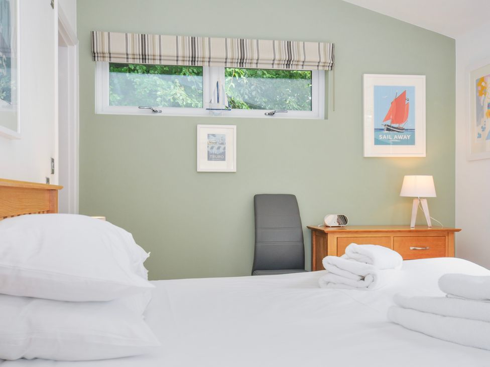 A bedroom with a bed, chair, and drawer at 15 Horizon View in Dobwalls