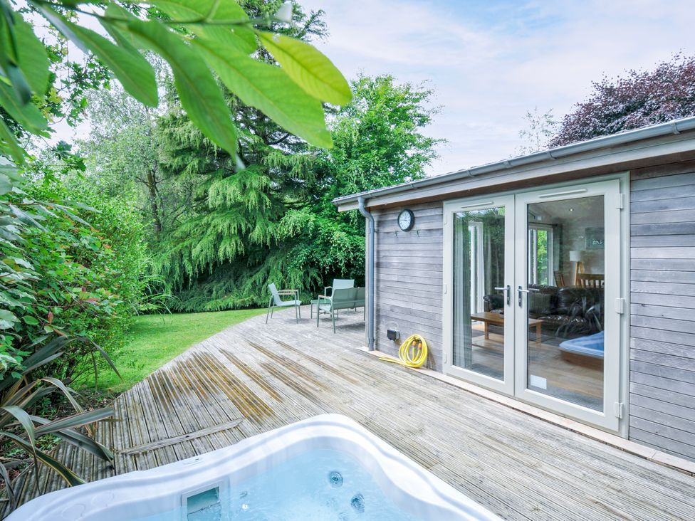 An outdoor area with a hot tub and deck at 15 Horizon View in Dobwalls