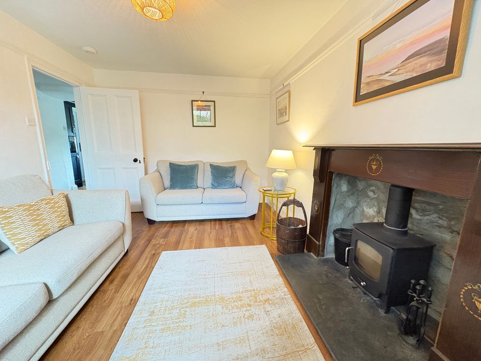 A living room with a sofa and a fireplace at Delfryn, Newport