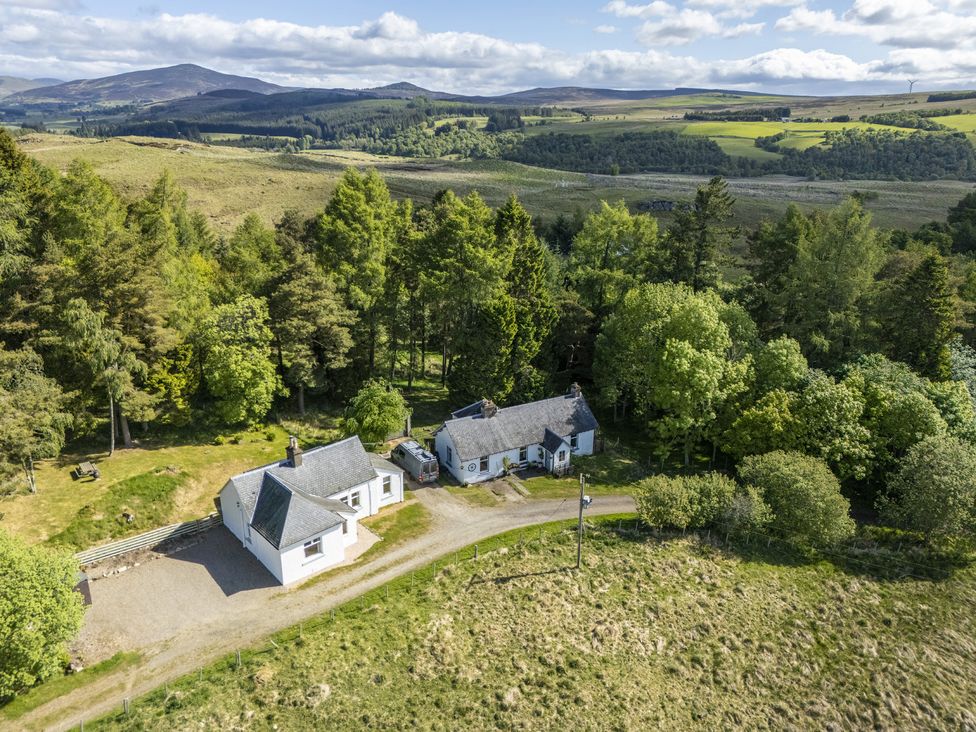 An aerial view of Upper Hillside Cottage surrounded by trees in Blairgowrie