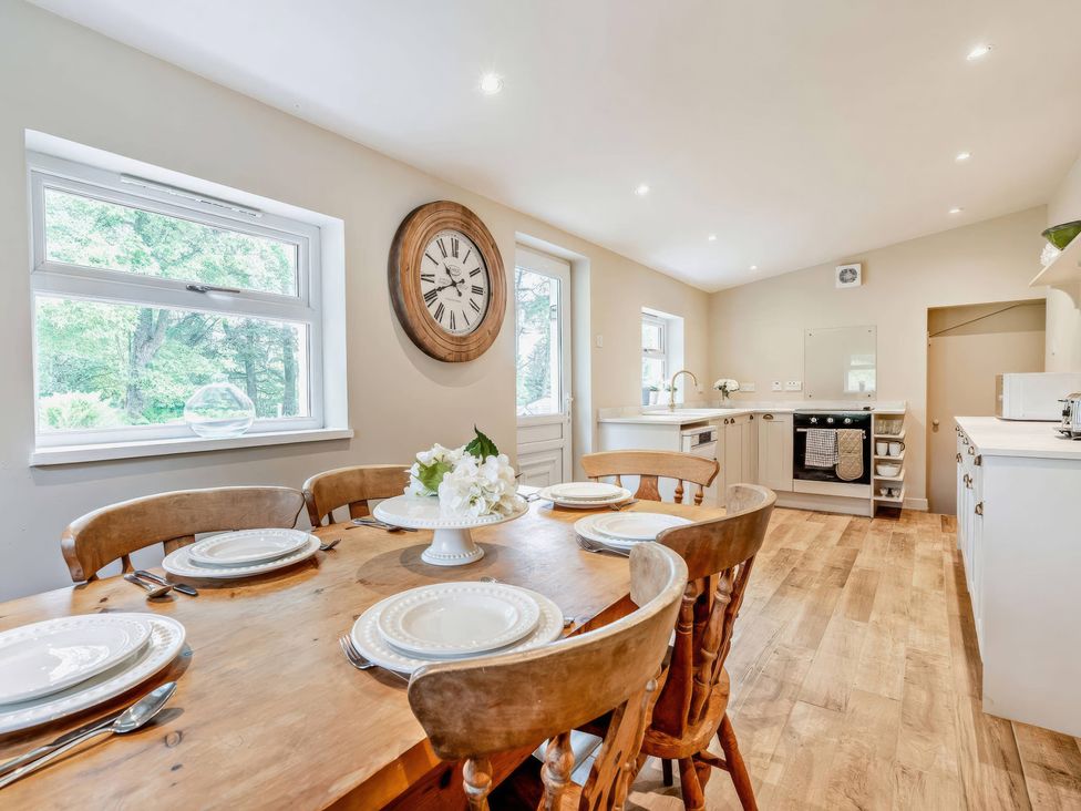 A kitchen with a dining table and chairs at Upper Hillside Cottage in Blairgowrie