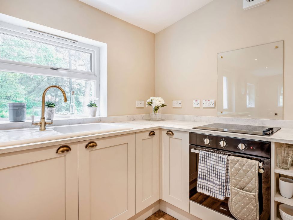 A kitchen with a sink and stove at Upper Hillside Cottage in Blairgowrie