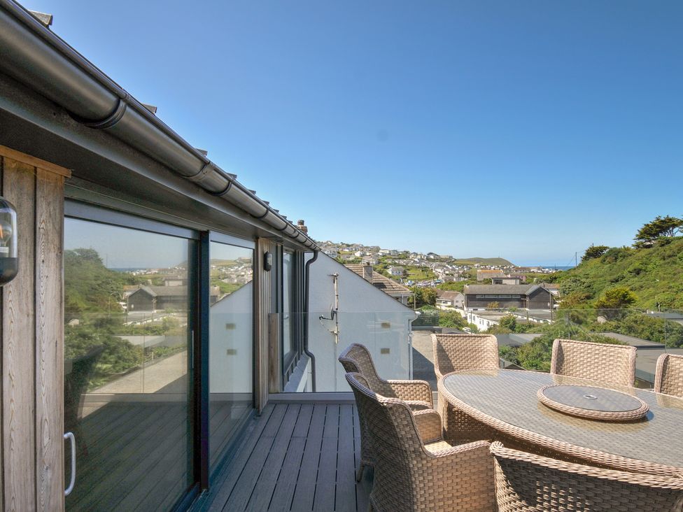 An outdoor dining area with a table and chairs at Breakers View in Polzeath