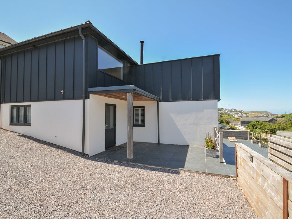 An outdoor area with a modern building and patio at Breakers View in Polzeath