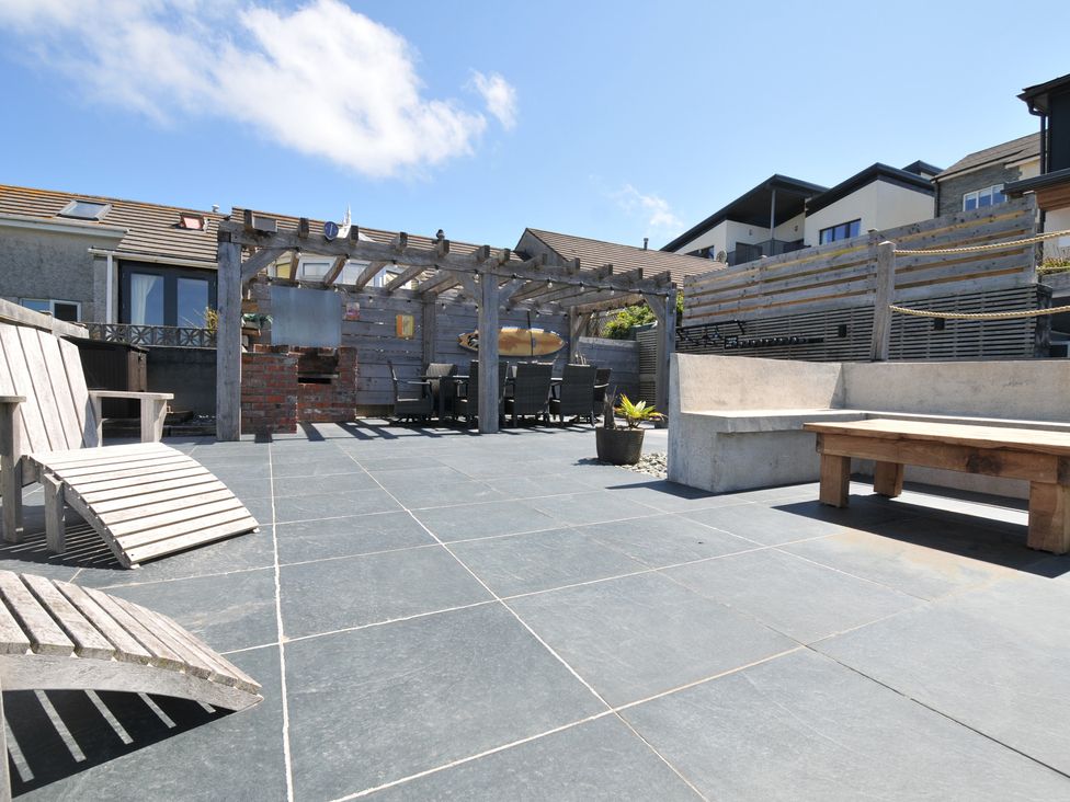 A patio area with outdoor furniture and a pergola at Breakers View in Polzeath