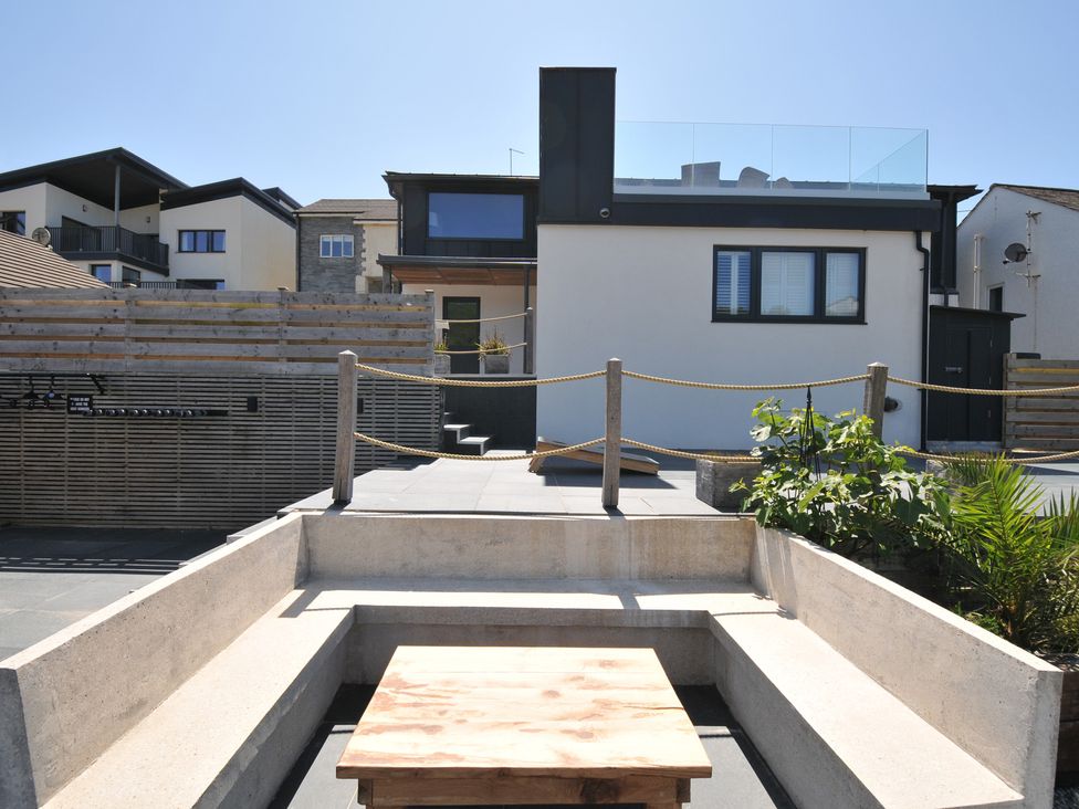 An outdoor area with a house and seating at Breakers View in Polzeath