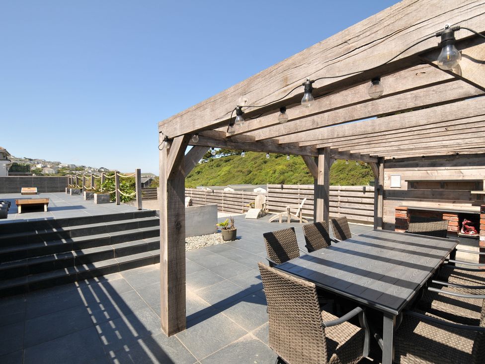 An outdoor space with a table and chairs at Breakers View in Polzeath