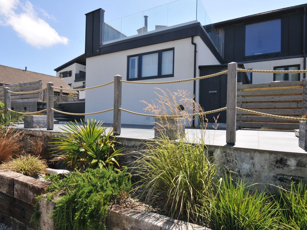 An outdoor area with a house, balcony, and plants at Breakers View in Polzeath