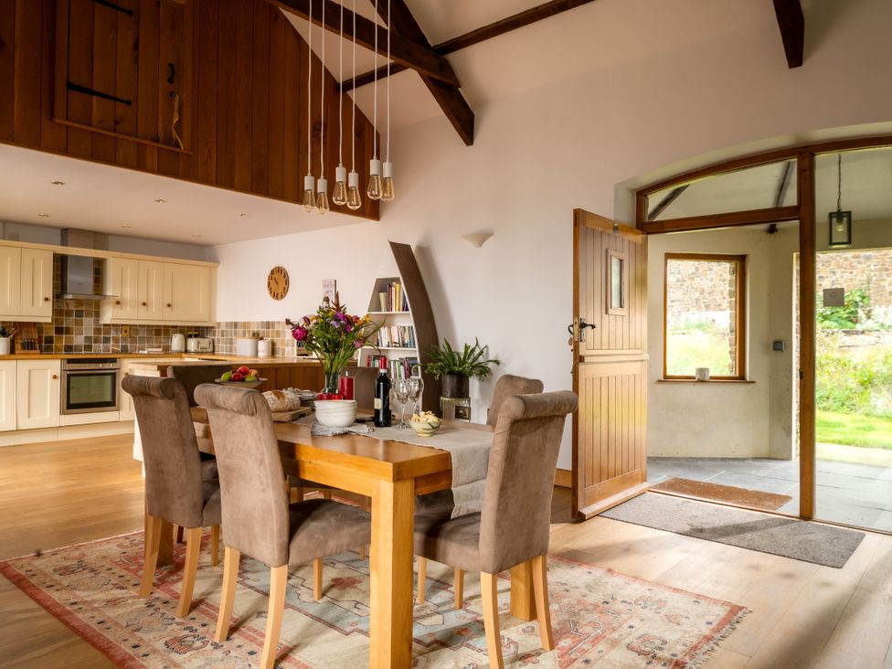 A dining room with a table and chairs at Hoppers Barn Pancrasweek near Holsworthy