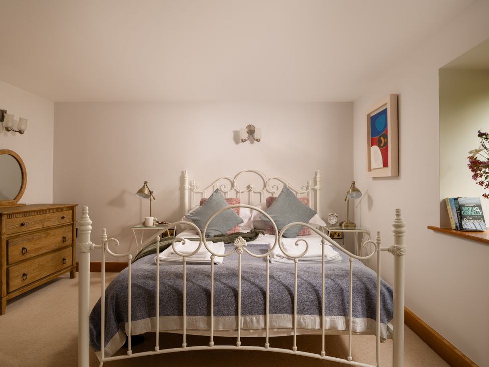 A bedroom with a bed and dresser at Hoppers Barn Pancrasweek near Holsworthy