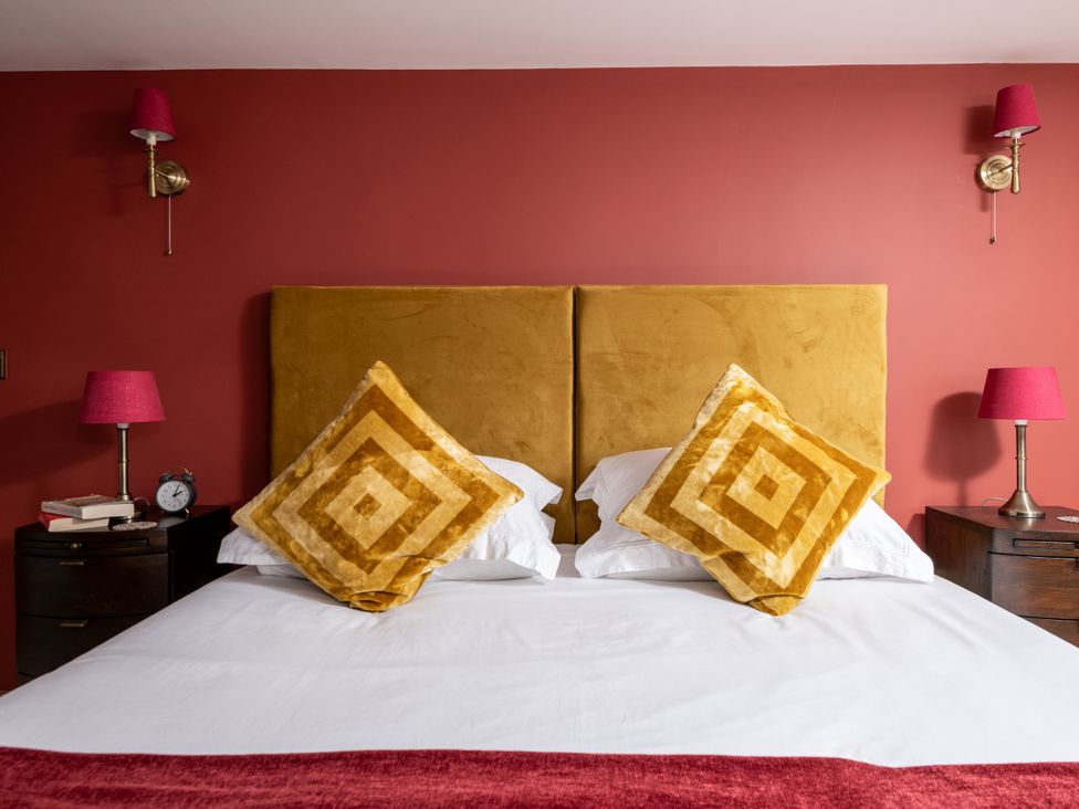 A bedroom with a bed and bedside tables at Hoppers Barn Pancrasweek near Holsworthy