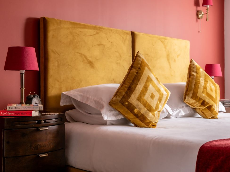 A bedroom with a bed and bedside table at Hoppers Barn Pancrasweek near Holsworthy