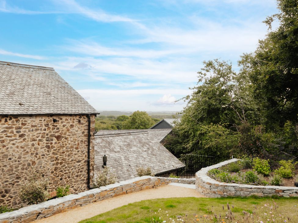 A view of stone buildings and a garden at Hoppers Barn Pancrasweek near Holsworthy