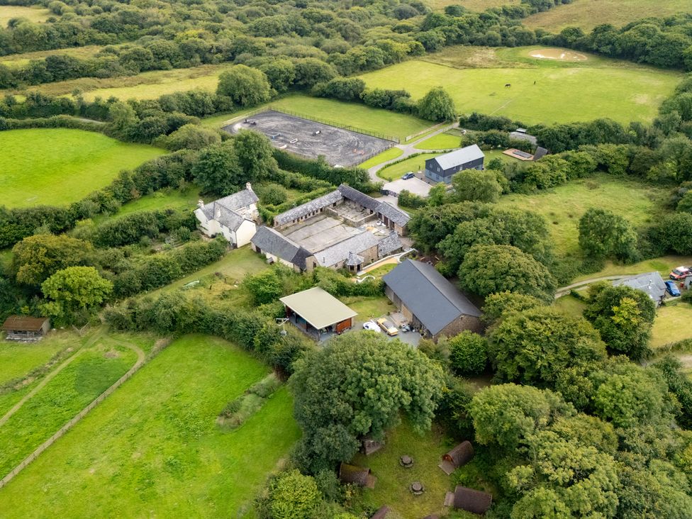An aerial view of a farmhouse and barns in a rural area at Hoppers Barn Pancrasweek near Holsworthy