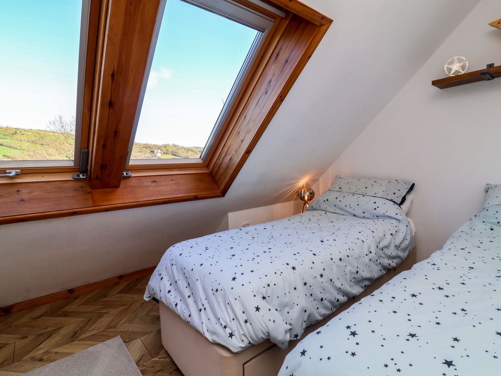 A bedroom with two beds and a window at Hillsview in Combe Martin