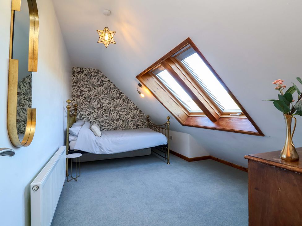 A bedroom with a bed and window at Hillsview in Combe Martin