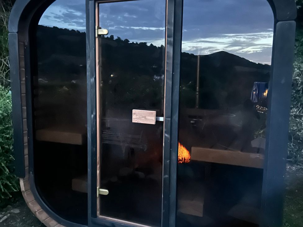 An outdoor sauna with a glass door at Hillsview in Combe Martin