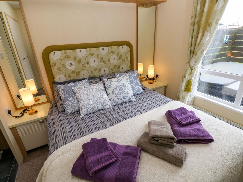 A bedroom with a bed and pillows at Reef Retreat in Little Haven