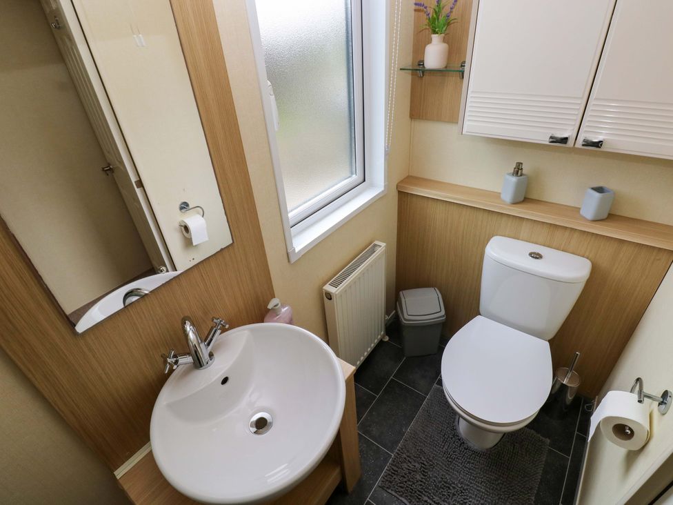 A bathroom with a sink and toilet at Reef Retreat in Little Haven