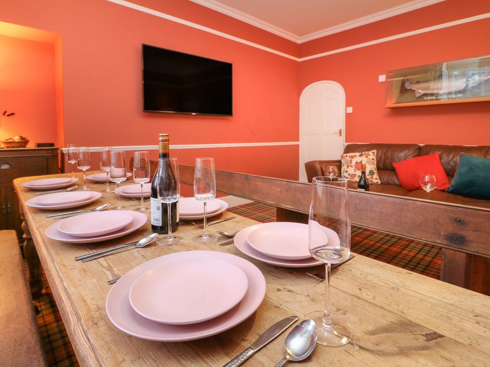 A dining room with a table set for dinner at The Smithy in Barnard Castle