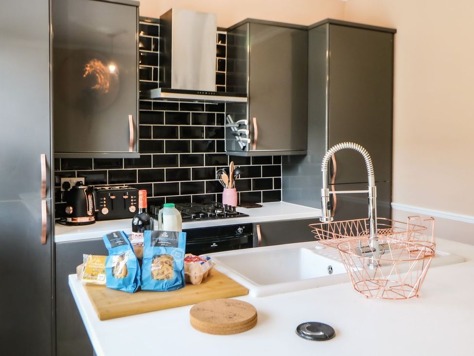 A kitchen with a sink and stove at The Smithy in Barnard Castle